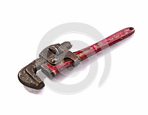 Old and rusty Stilson wrench with red aged handler