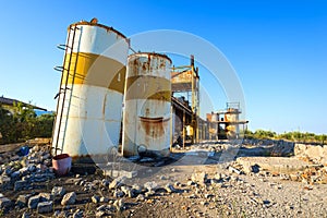 Old, rusty storage tanks in an abandoned industrial unit, Greece.