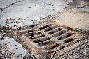 Old rusty street grate near the sea in Cres