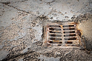 Old rusty street grate near the sea in Cres