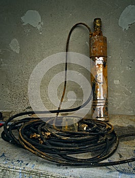 Old rusty submersible pump for drinking water