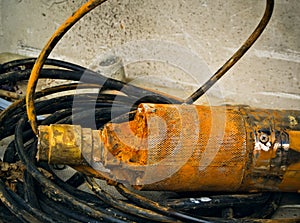 Old rusty submersible pump for drinking water