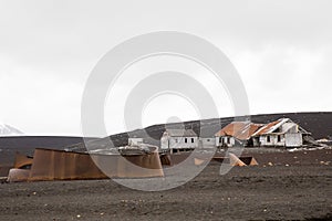 Old rusty tanks and buildings for the remains of the old whaling station at Whalers Bay, Deception Island, Antarctica