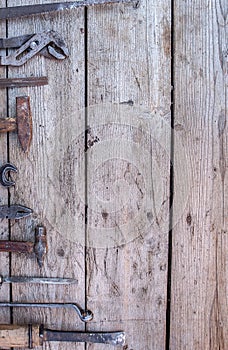 Old, rusty tools lying on a black wooden table. Hammer, chisel, hacksaw, metal wrench.Copy space