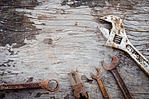 Old rusty tools on old wood background. wrench on wooden. rustic styles.