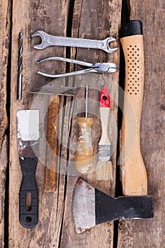 Old rusty tools on a wooden boards background.