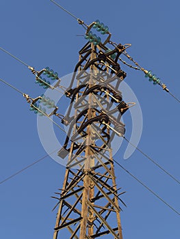 Old rusty tower phylon of a power delivery overhead line