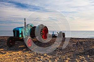 Old rusty tractor on the empty Cromer beach, Great Britain