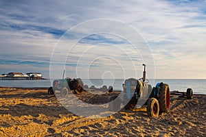 Old rusty tractor on the empty Cromer beach, Great Britain