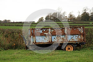 Old rusty Trailer in a field