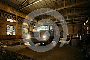 Old rusty truck in abandoned factory warehouse