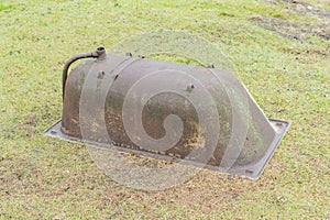 An old rusty tub is lying in the yard