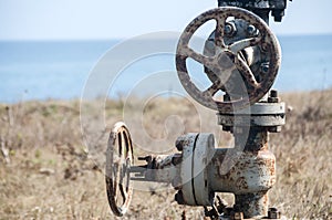 Old rusty valve closeup at seashore