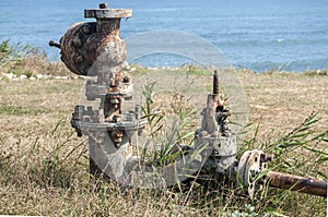 Old rusty valve closeup at seashore