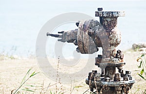 Old rusty valve closeup at seashore