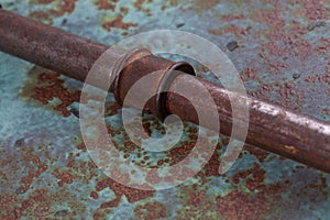 Old rusty valve pipes on rusty metal wall background