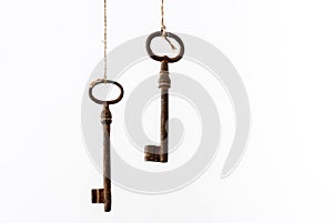 Old rusty vintage keys suspended on the laces