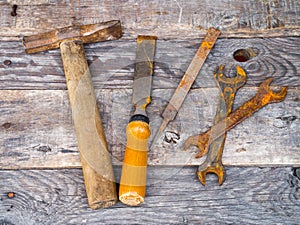 Old rusty vintage tools on weathered background