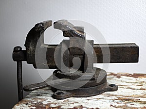 Old rusty vise on a wooden bench. Tool for locksmith