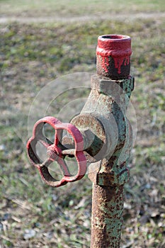 Old rusty water pipe with tap