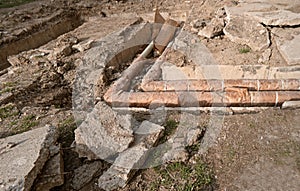 Old rusty water pipes in concrete trench. Underground utility and services pipe lay at the construction site. Repairing