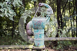 Old rusty water pump in the forest