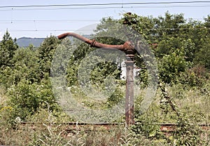 Old rusty water pump for locomotives