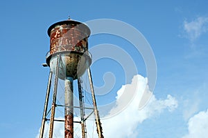 Old rusty watertower against blue sky