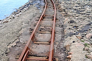 Old rusty weathered railroads right at the baltic sea coast