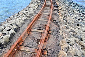 Old rusty weathered railroads right at the baltic sea coast