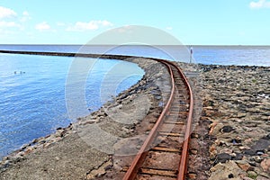 Old rusty weathered railroads right at the baltic sea coast