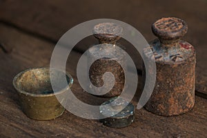 Old rusty weights on a wooden table