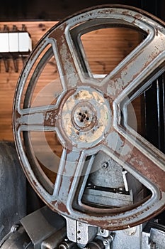 Old and rusty wheel of an antique movie projector