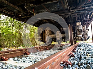 Old rusty wheel of retires train on the inactive rail track