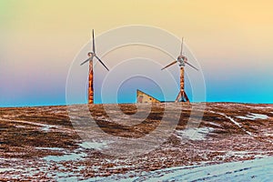Old and rusty wind mills on a snow mountain