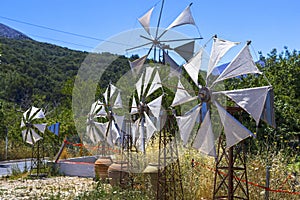 Old rusty windmills on the field. Agriculture in Greece