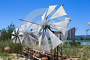 Old rusty windmills on the field. Agriculture in Greece