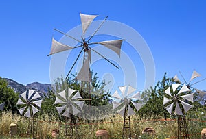 Old rusty windmills on the field. Agriculture in Greece