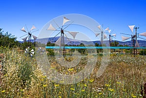 Old rusty windmills on the field. Agriculture in Greece