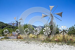 Old rusty windmills on the field. Agriculture in Greece