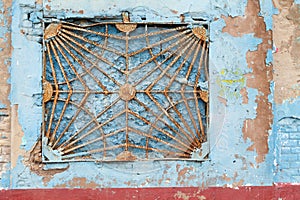 Old rusty window grates on the street in El Cabanyal, Valencia city.