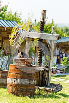 Old rusty wine press with oak barrel.