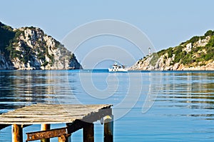 Old rusty wooden dock at sunny morning, Porto Koufo harbor