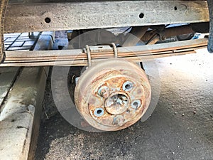 Old rusty worn drum brakes of a truck, car. Automotive suspension repair. Replacing wheel