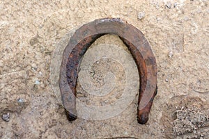 Old rusty and worn horseshoes  on white with natural shadows