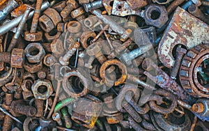 Old, rusty, worn metal details- bolts, nuts, bearings, chain lie