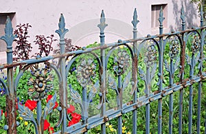 Old rusty wrought iron fence painted blue