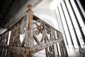 An old rusty wrought-iron railing