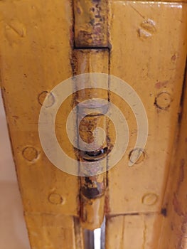 old rusty yellow door hinges