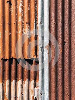 Old and rusty zinc sheet wall. Vintage style metal sheet roof texture. Pattern of old metal sheet. Rusting metal or siding.